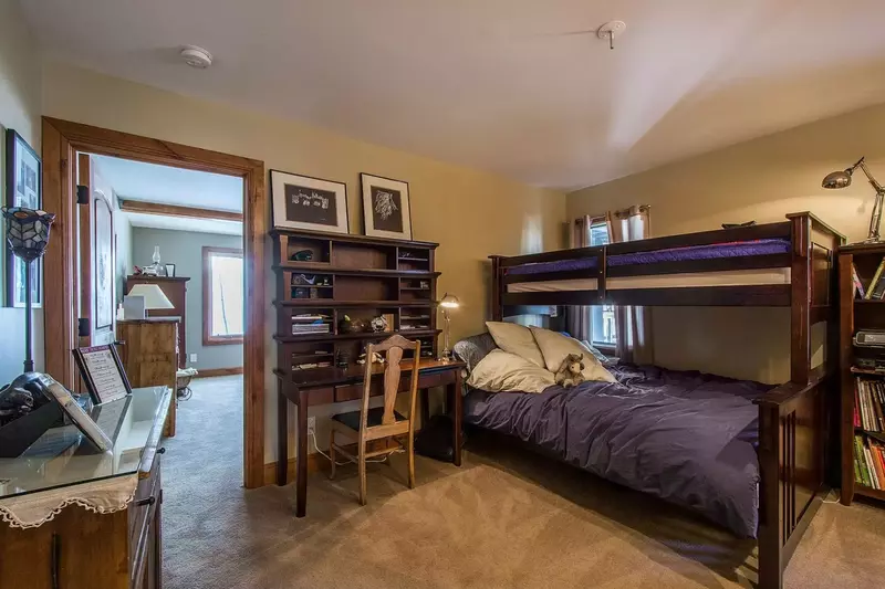 Guest bedroom wih bunk beds, full on bottom, twin on top. A desk and chair to write out post cards or journal the adventures of the day.