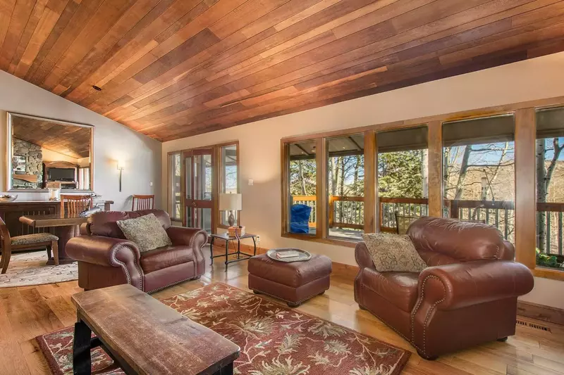 Living room with oversized leather furnishing, hardwood floors and panoramic views.