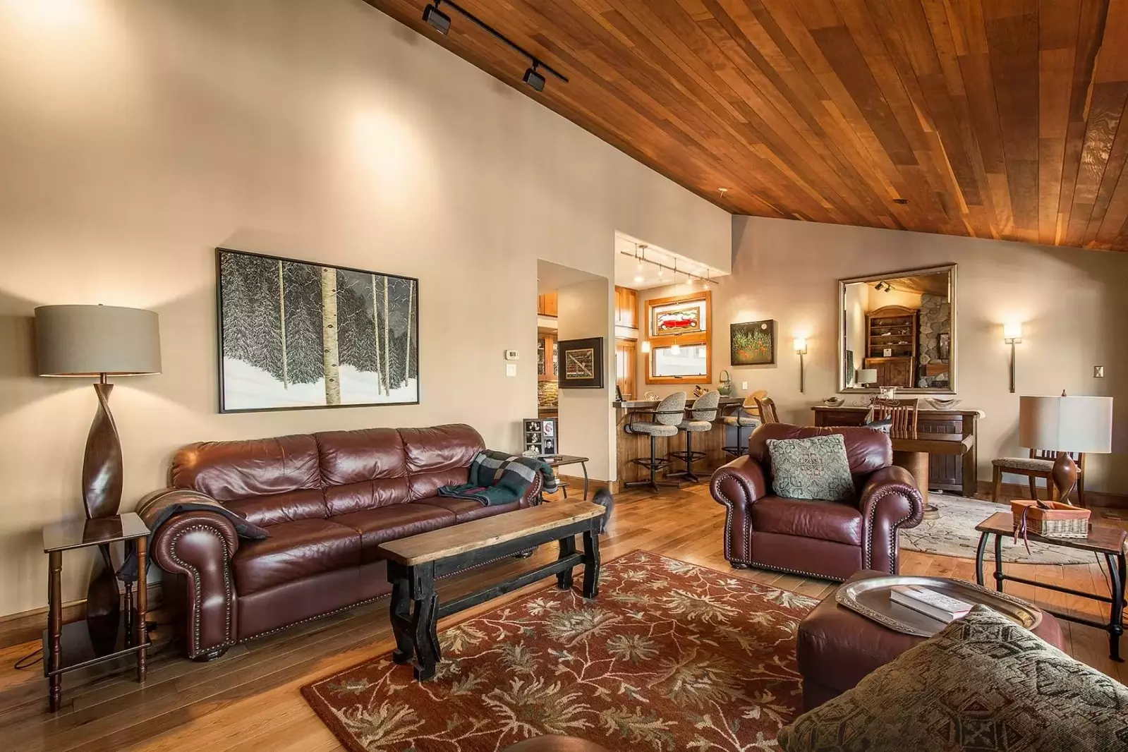 Handcrafted lamps, coffee and end tables adorn the living area.