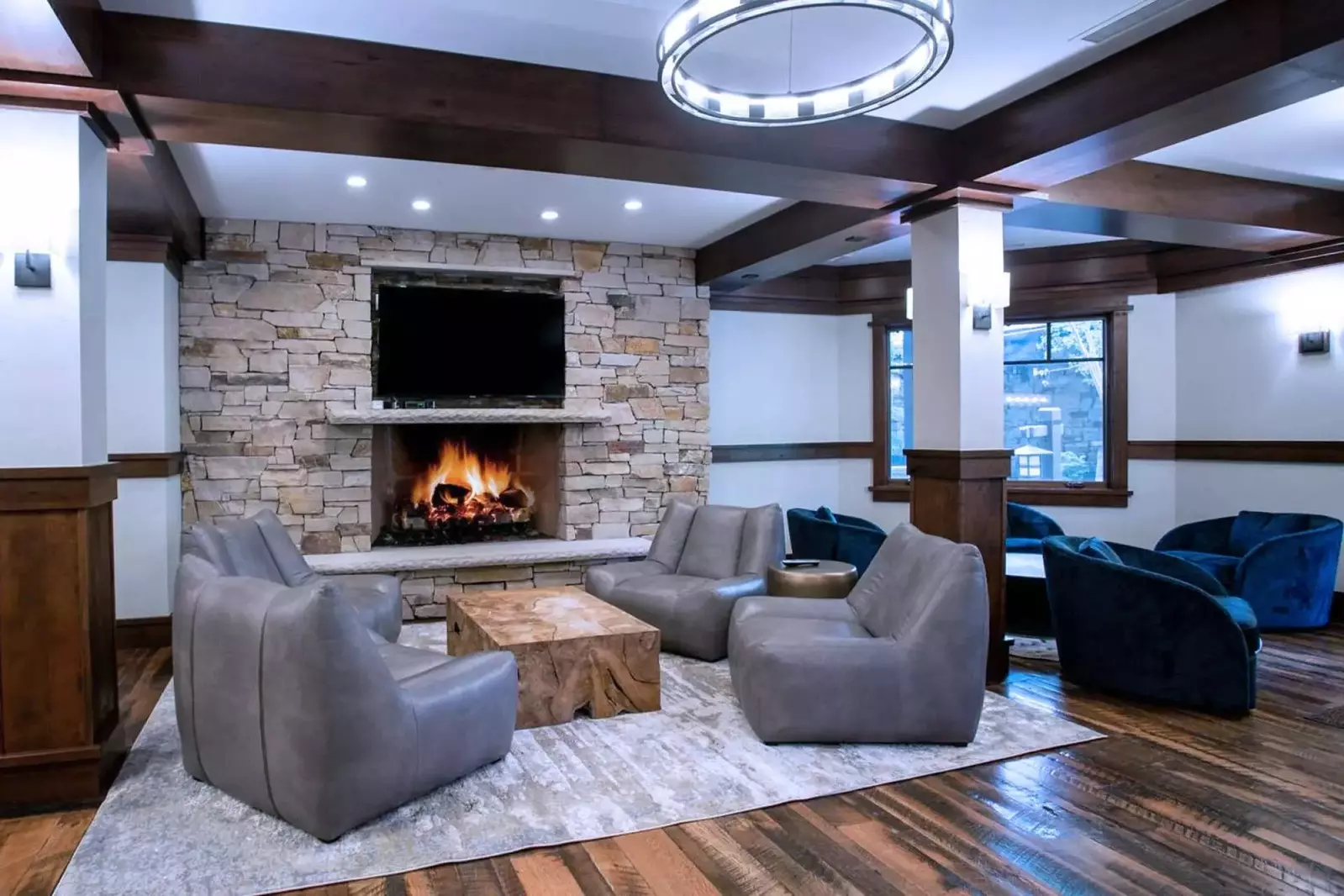 Arrowleaf's Hearth Room includes large fieldstone fireplace, library seating area, shuffle board, pool table and a professional espresso machine.