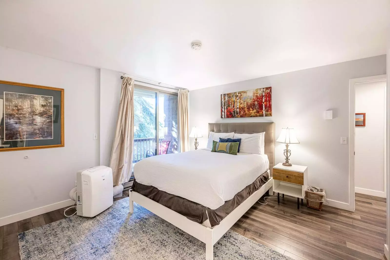 The primary suite features a private patio with room darkening curtains. During warmer summer months the portable AC cools the home off wonderfully.