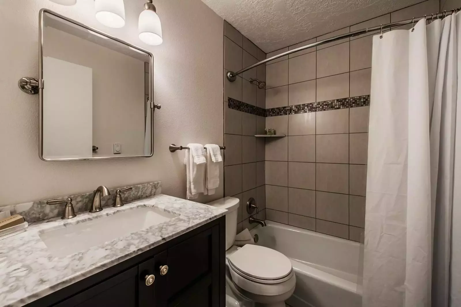 The master bathroom (1) is equipped with a granite vanity, stainless steel finishes, full size bathtub and shower.