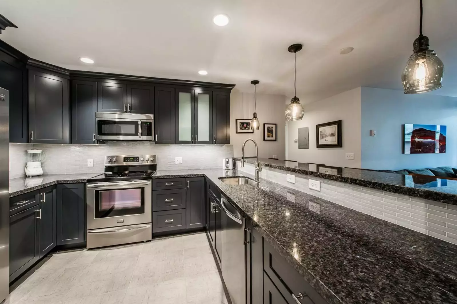 Gourmet kitchen looks out to the living area and is complete with stainless steel appliances, hardwood cabinets, granite counters and breakfast bar.