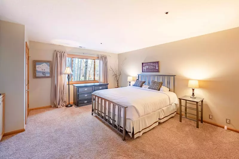 An inviting guest suite features a plush queen size mattress, HDTV, En suite bathroom. and small porch.