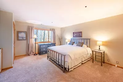 An inviting guest suite features a plush queen size mattress, HDTV, En suite bathroom. and small porch.