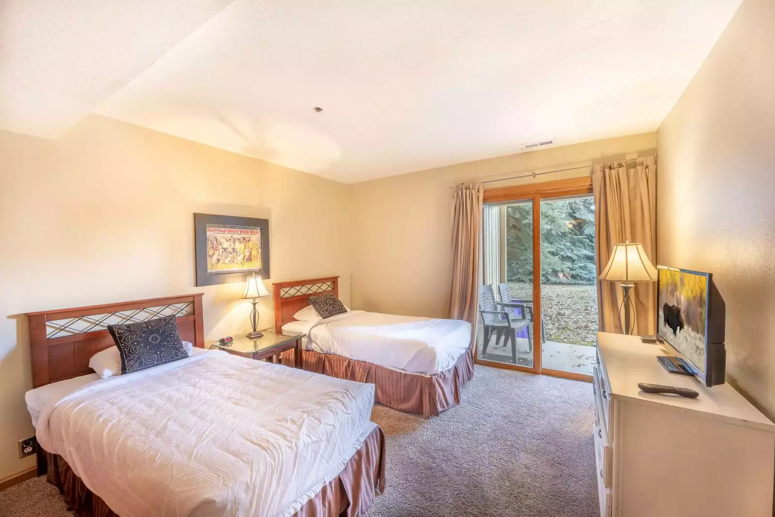 Bright and Cheerful Guest Suite Features Two Twin Beds, Smart HDTV, Sliding Glass Door to Patio