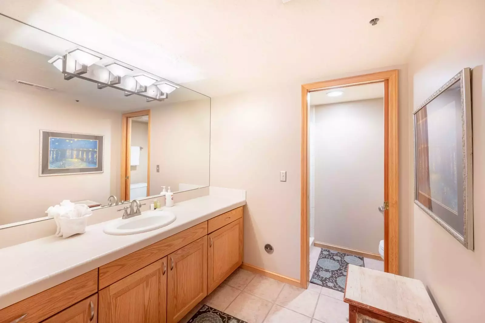 The guest bathroom features an oversized vanity with ample counter space with it's separate room for the toilet/shower it is perfect for families