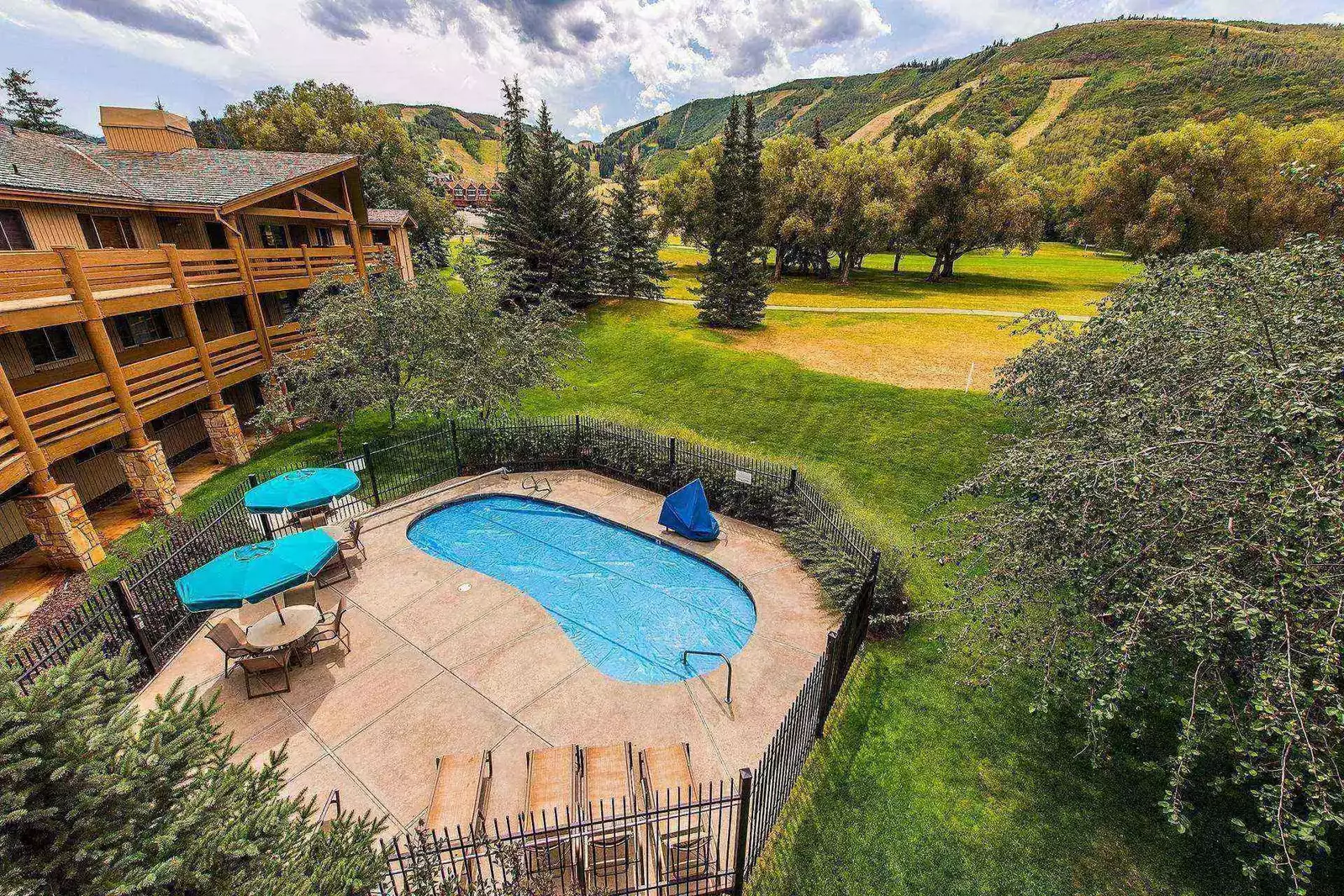 Poolside and golf course aerial view taken from directly above the home.