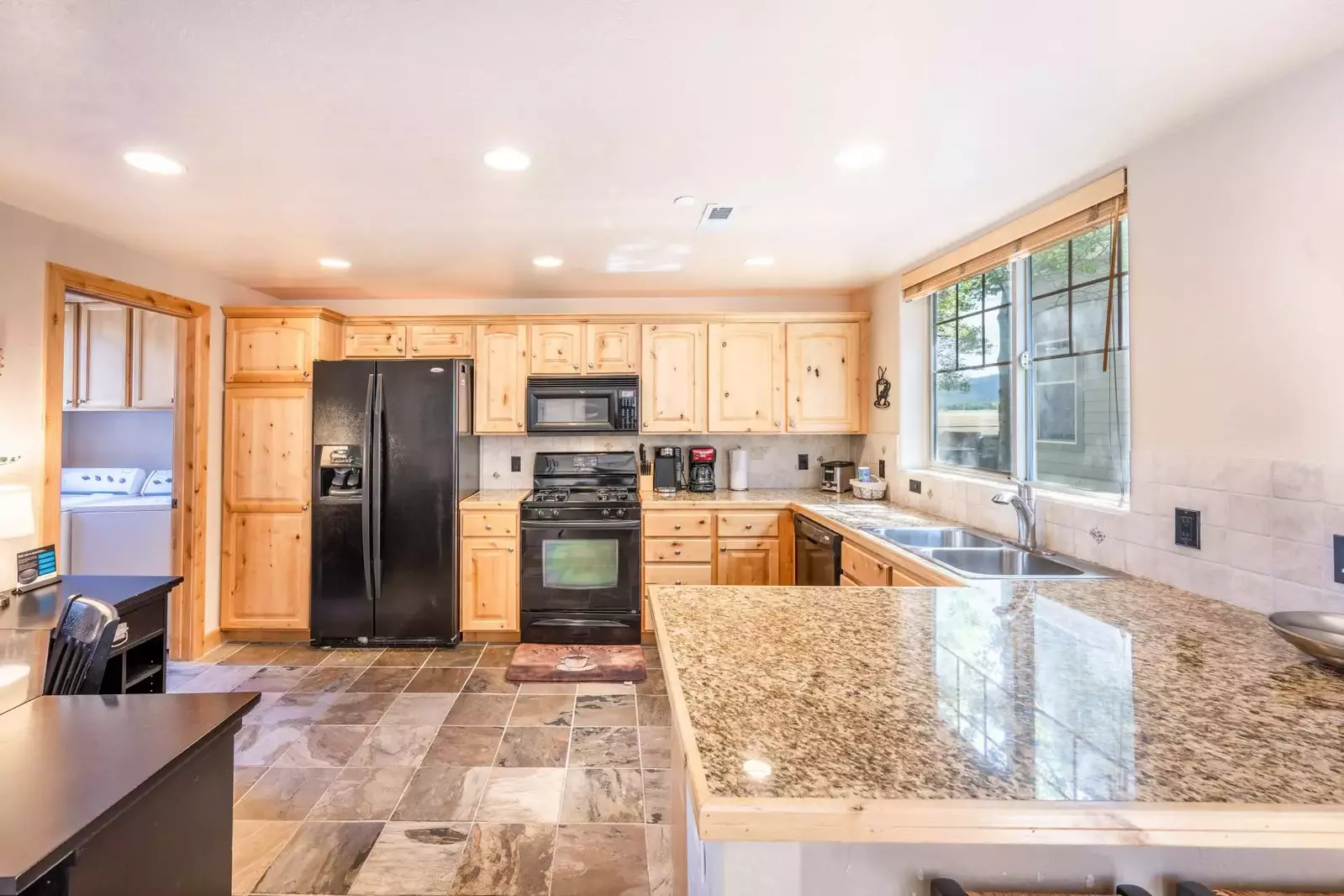 The kitchen is fully stocked and ready to make wonderful meals at home! There is plenty of seating at both the dining table and the breakfast bar.