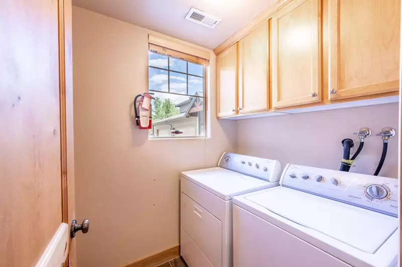 The laundry room is located off the kitchen and features a full size washer and dryer