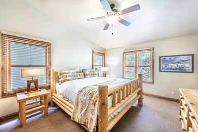 The first bedroom (1) has a king size bed with custom log pole bed frame, vaulted ceilings, two large closets, a 37” HDTV and a private en suite bathr