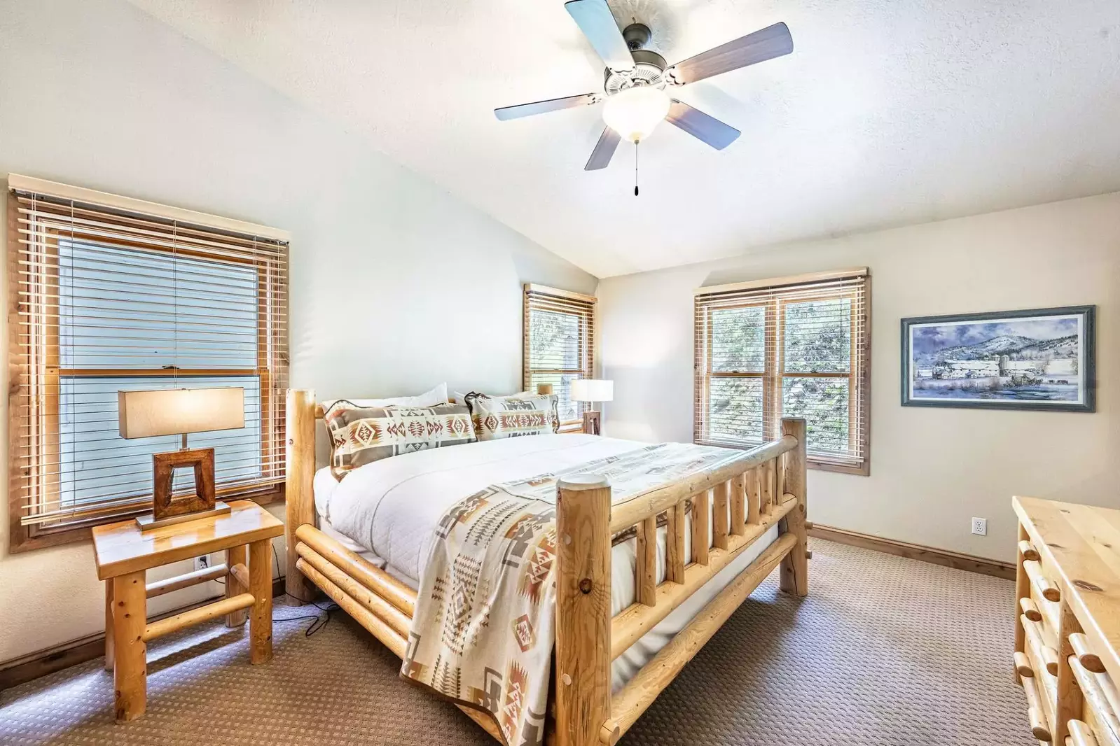 The first bedroom (1) has a king size bed with custom log pole bed frame, vaulted ceilings, two large closets, a 37” HDTV and a private en suite bathr