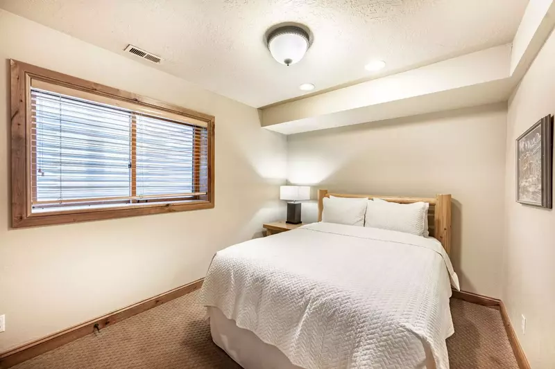 First Floor Guest Suite offers a Queen Bed with a custom log pole bed