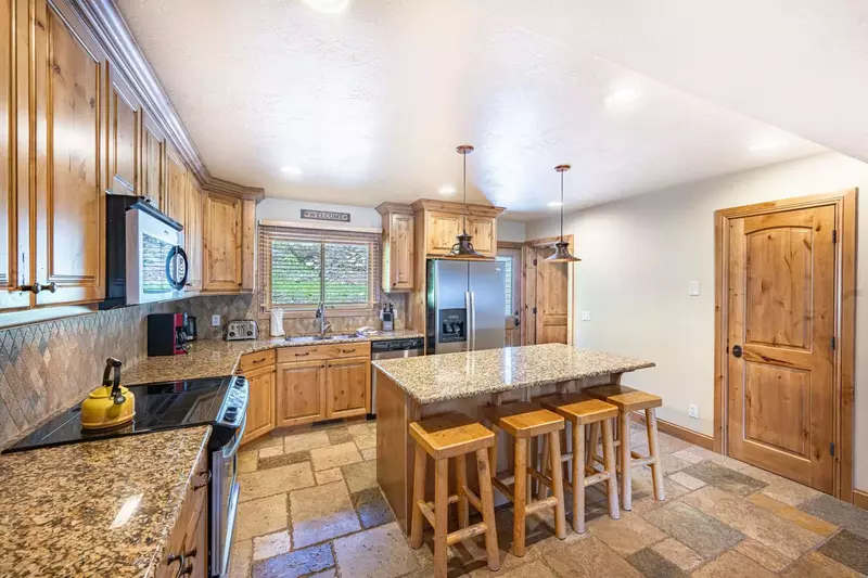 The gourmet kitchen is fully equipped with a complete range of household appliances including a fridge, oven & stove, dishwasher and microwave.