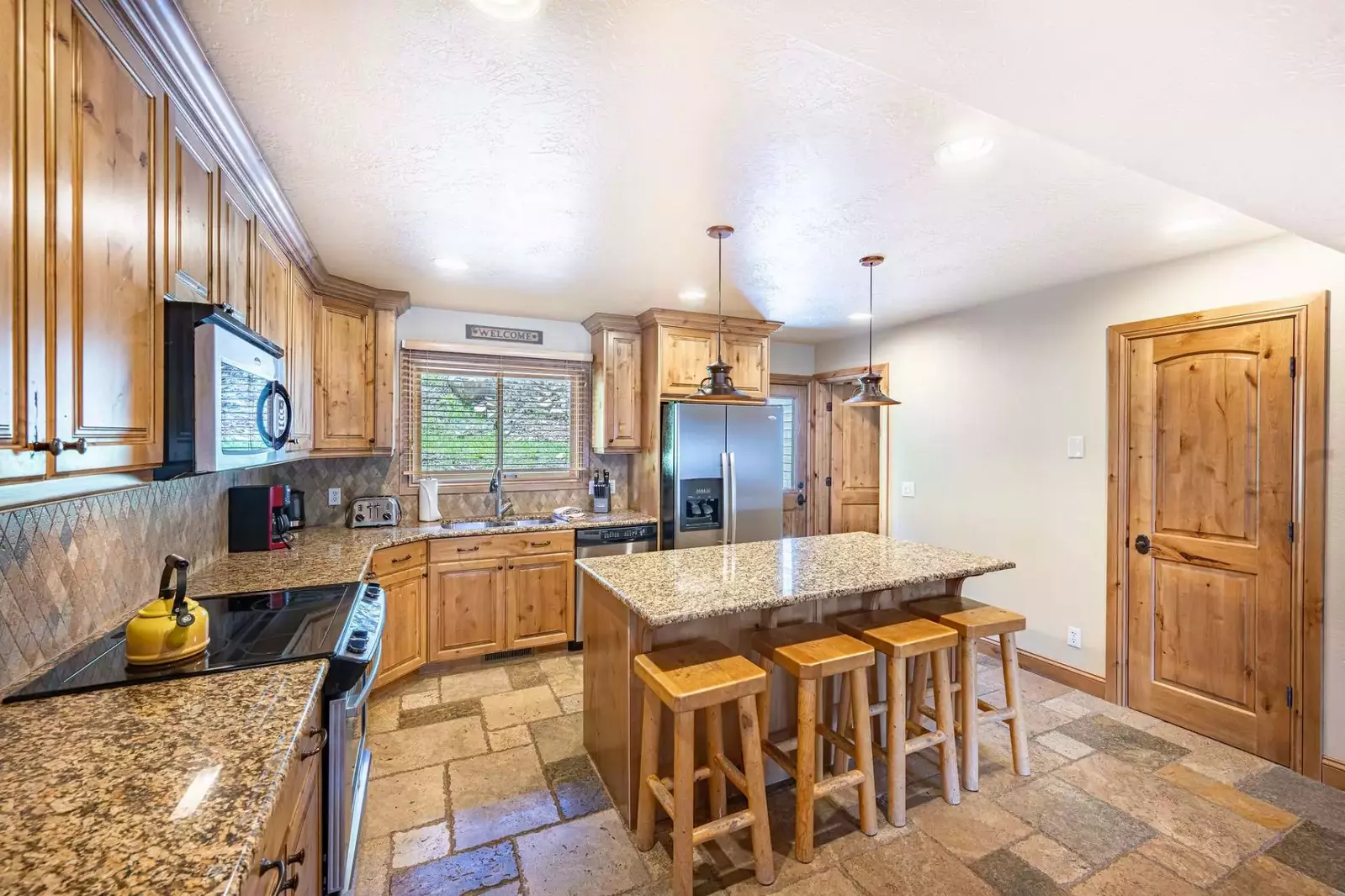 The gourmet kitchen is fully equipped with a complete range of household appliances including a fridge, oven & stove, dishwasher and microwave.