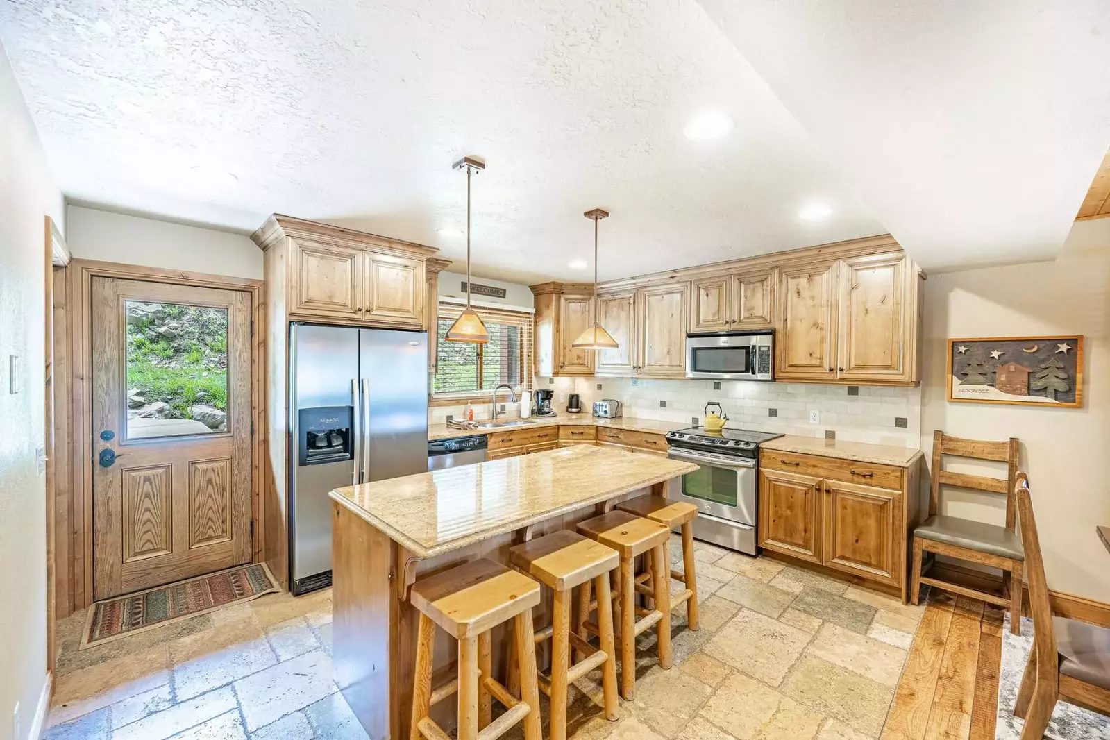 Fully stocked kitchen with breakfast bar for 4, granite countertops, stainless steel appliances