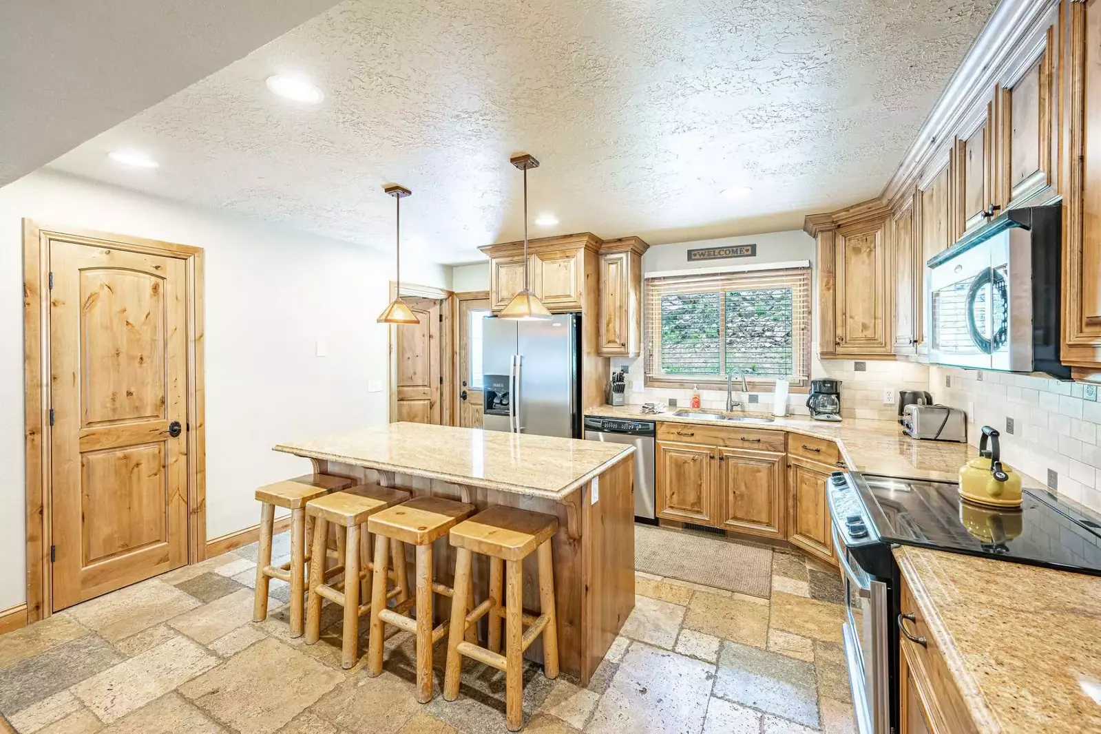 Renovated kitchen, well stocked with a coffee maker, toaster, blender; all the comforts of home!