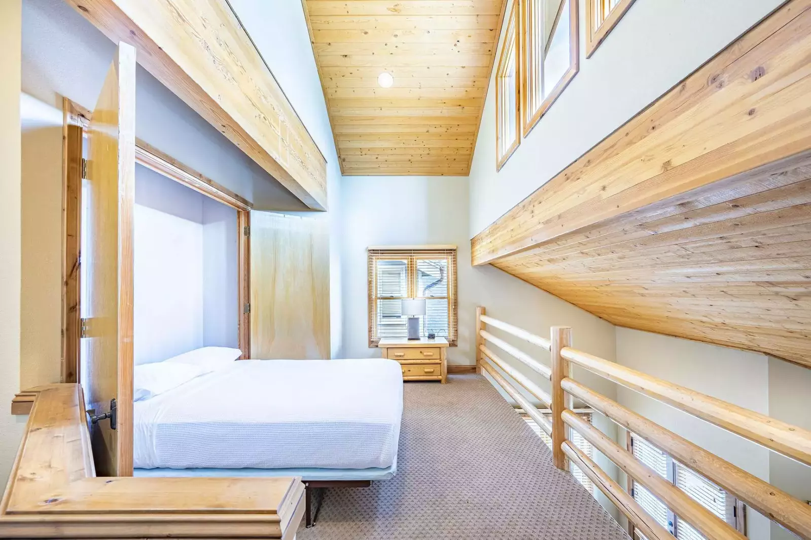 Bright & Spacious loft bedroom has vaulted ceilings and a queen size murphy bed. It overlooks the living area and is perfect for large groups or famil