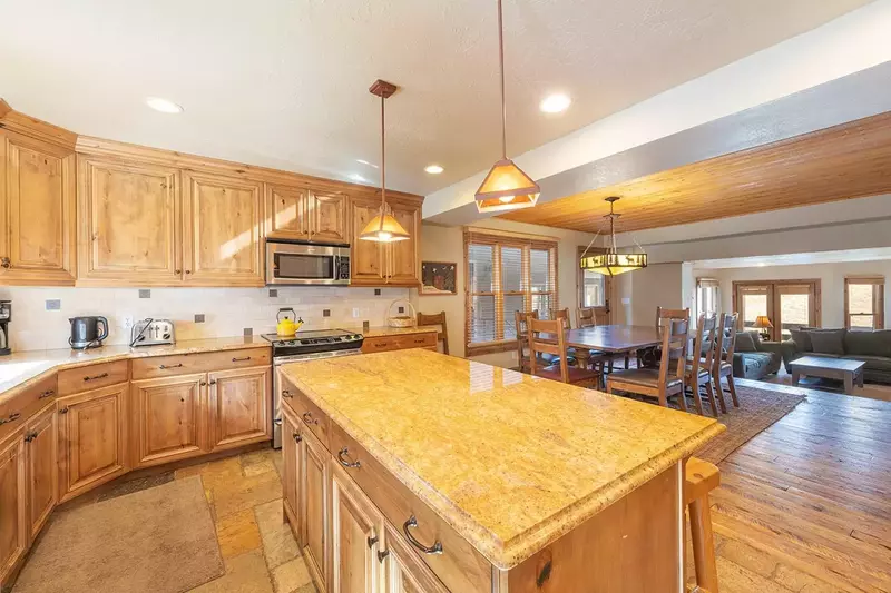 Luxury kitchen w breakfast bar for 4, granite countertops, stainless steel appliances, hardwood flooring, formal dining for 10