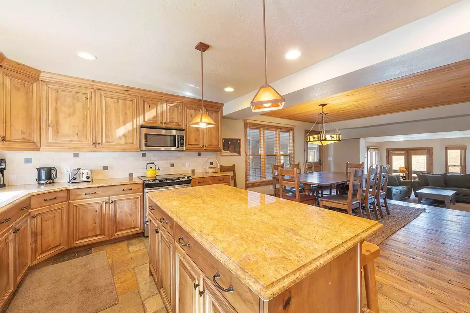 Luxury kitchen w breakfast bar for 4, granite countertops, stainless steel appliances, hardwood flooring, formal dining for 10