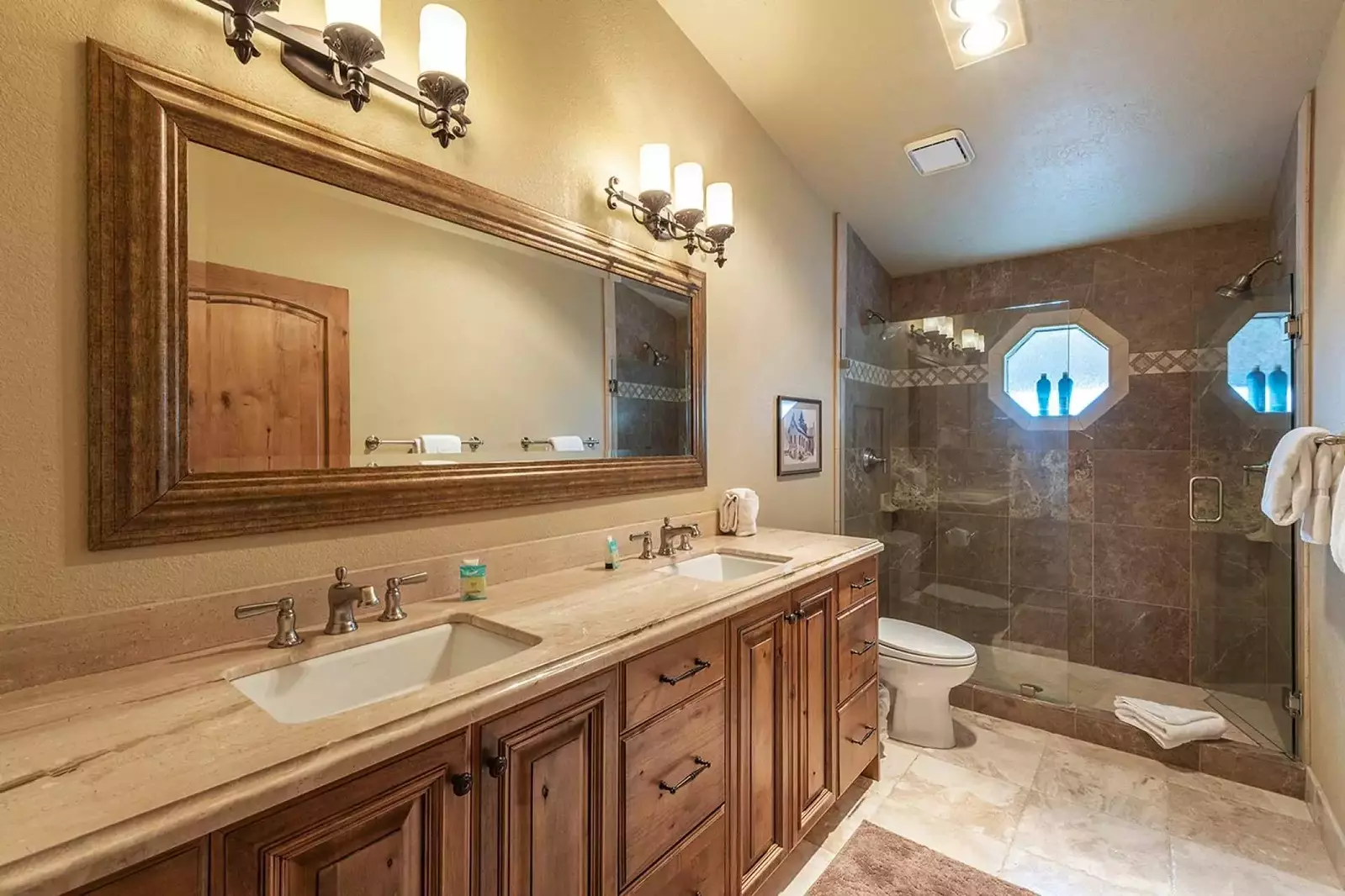 The master en suite was fully renovated and has a granite countertop with a his and hers vanity, a walk-in glass shower and stainless steel finishes.