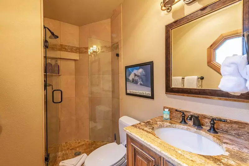 Walk-in shower enclosed by glass draws your eye as soon as you enter the bathroom. .