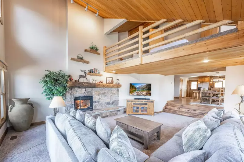 The bright and spacious family room is the gathering spot of the home. With vaulted ceilings, gas fireplace and comfortable furnishings it's a perfect