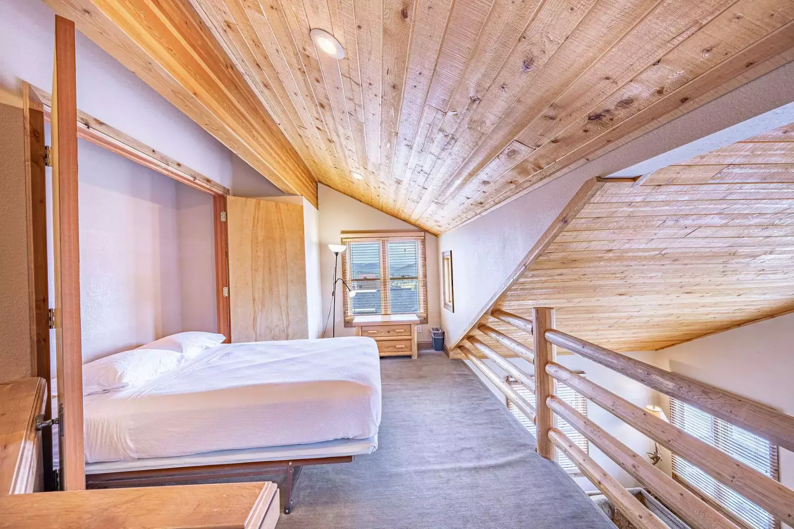 The loft offers up a queen-size murphy bed, deep lounge chair with footstool and a dresser for storage.