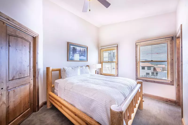 BEDROOM #2 features a queen size bed with custom log pole bed frame with comfortable linens and bedding.