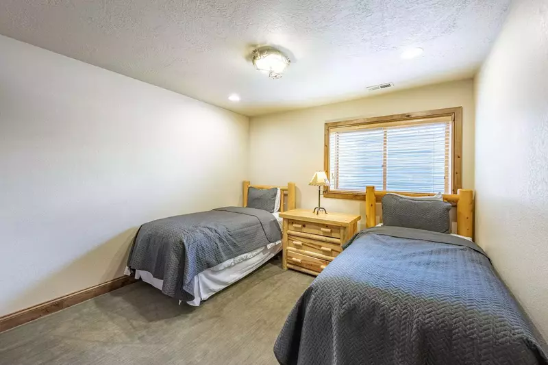 Guest Suite features two (2) twin beds with hardwood bed frames, closet and shares the fourth bathroom.