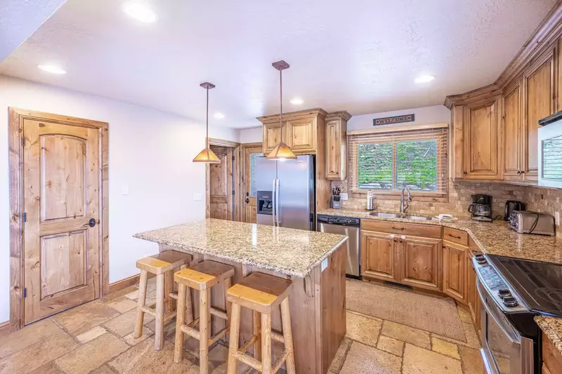 The Bright & Spacious Kitchen Features Beautiful Granite Counter Tops, Full Size Stainless Steel Appliances, Hardwood cabinetry is fully stocked with