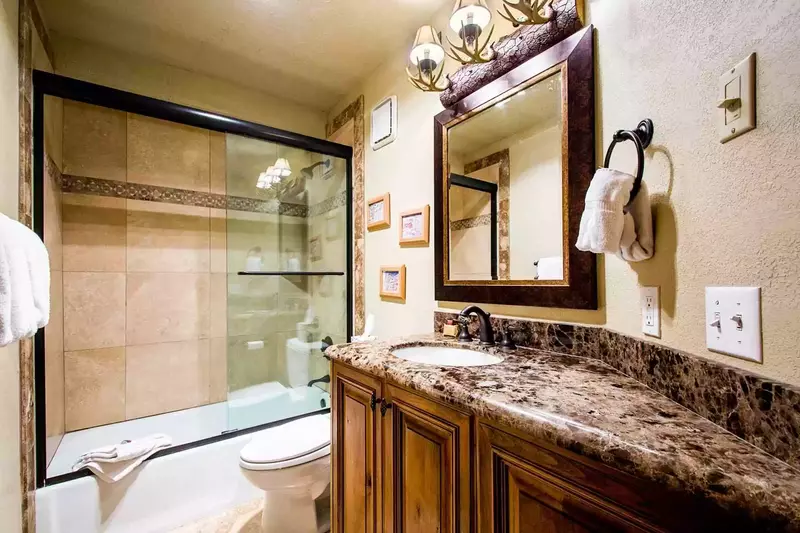 The fourth bathroom was also recently renovated and has a granite countertop with sink, stone tile flooring, bathtub and shower.