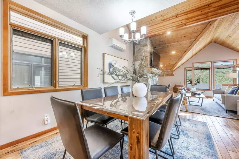 Experience the perfect family meal in our warm and inviting dining room. Adorned with a stunning hardwood table, eight chairs, and a comfortable break