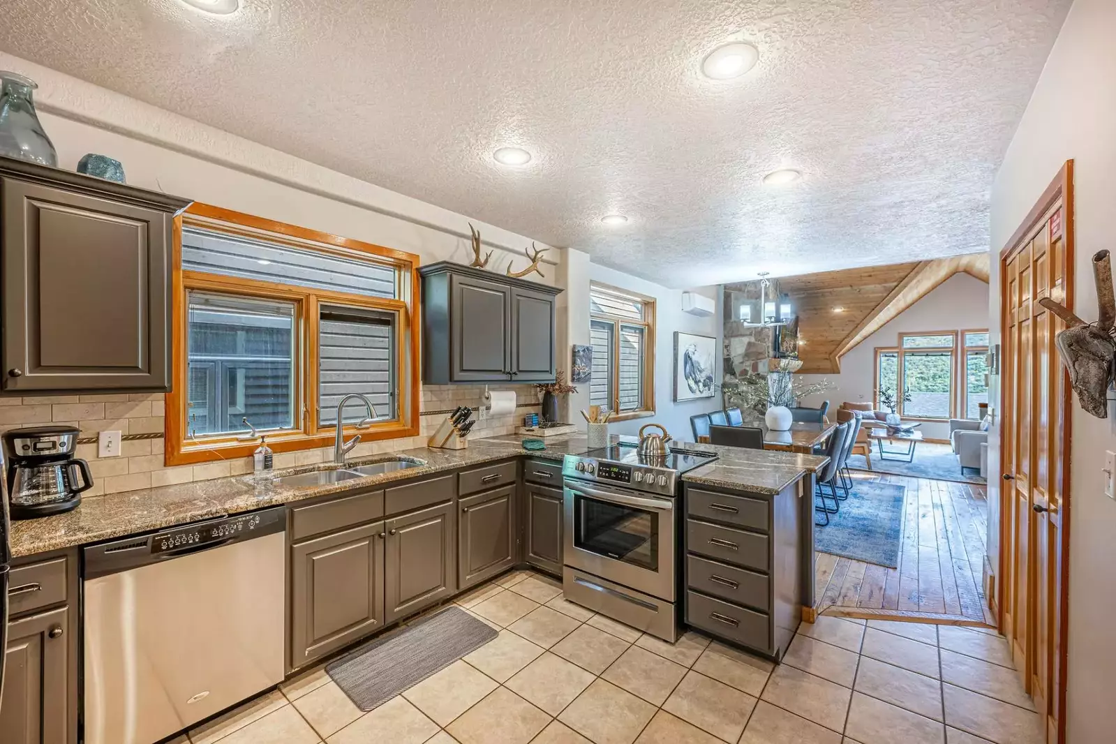 The newly updated kitchen is complete with a wide array of stainless steel appliances, has an assortment of high-quality dishes, and a comprehensive s