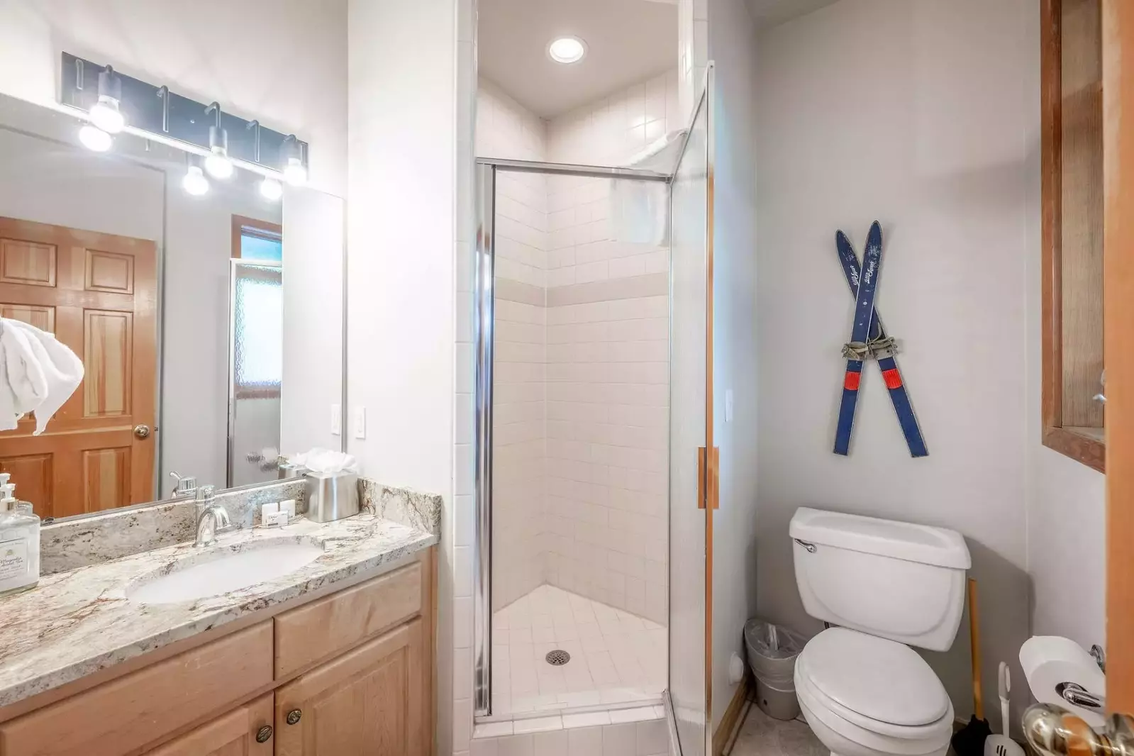 Welcome to our cozy home! The main floor bathroom boasts a stunning vanity with sleek stainless steel finishes and a spacious walk-in glass shower. Co