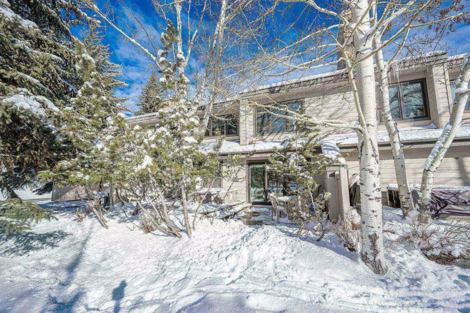 The back deck of the home offers privacy with the lush trees while you take in the mountain views.