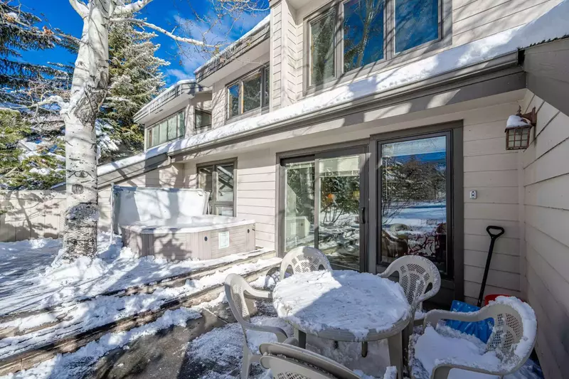 Private deck with table and chairs, and a private hot tub offers one of a kind lake and mountain views