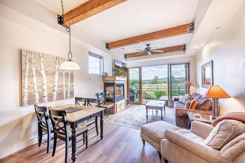 The living room of the home opens right to the private patio with the private hot tub and views of the nature preserve