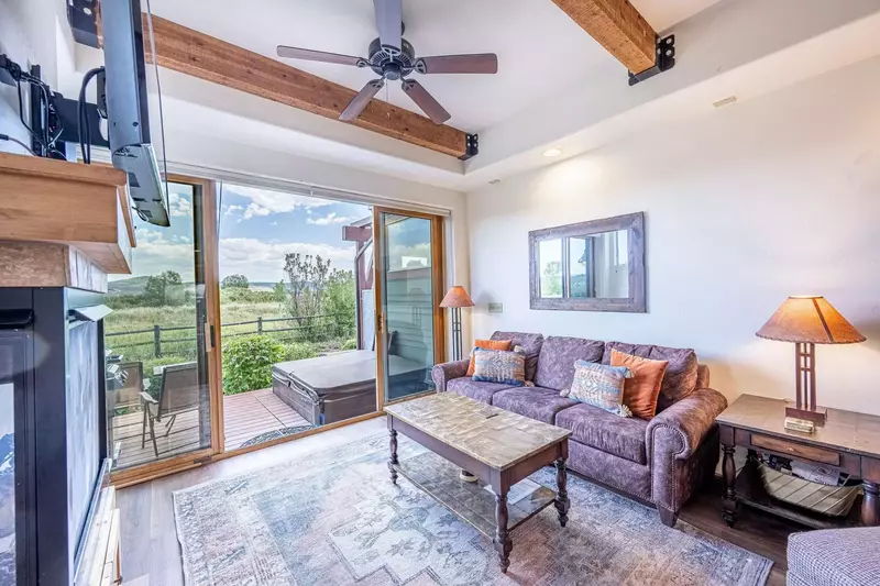 The Warm and Inviting Family Room Features a. Gas Fireplace, Oversized Sofa w Queen Sleeper, 42" HDTV, Sliding Glass Doors to Private Deck, Private Ho