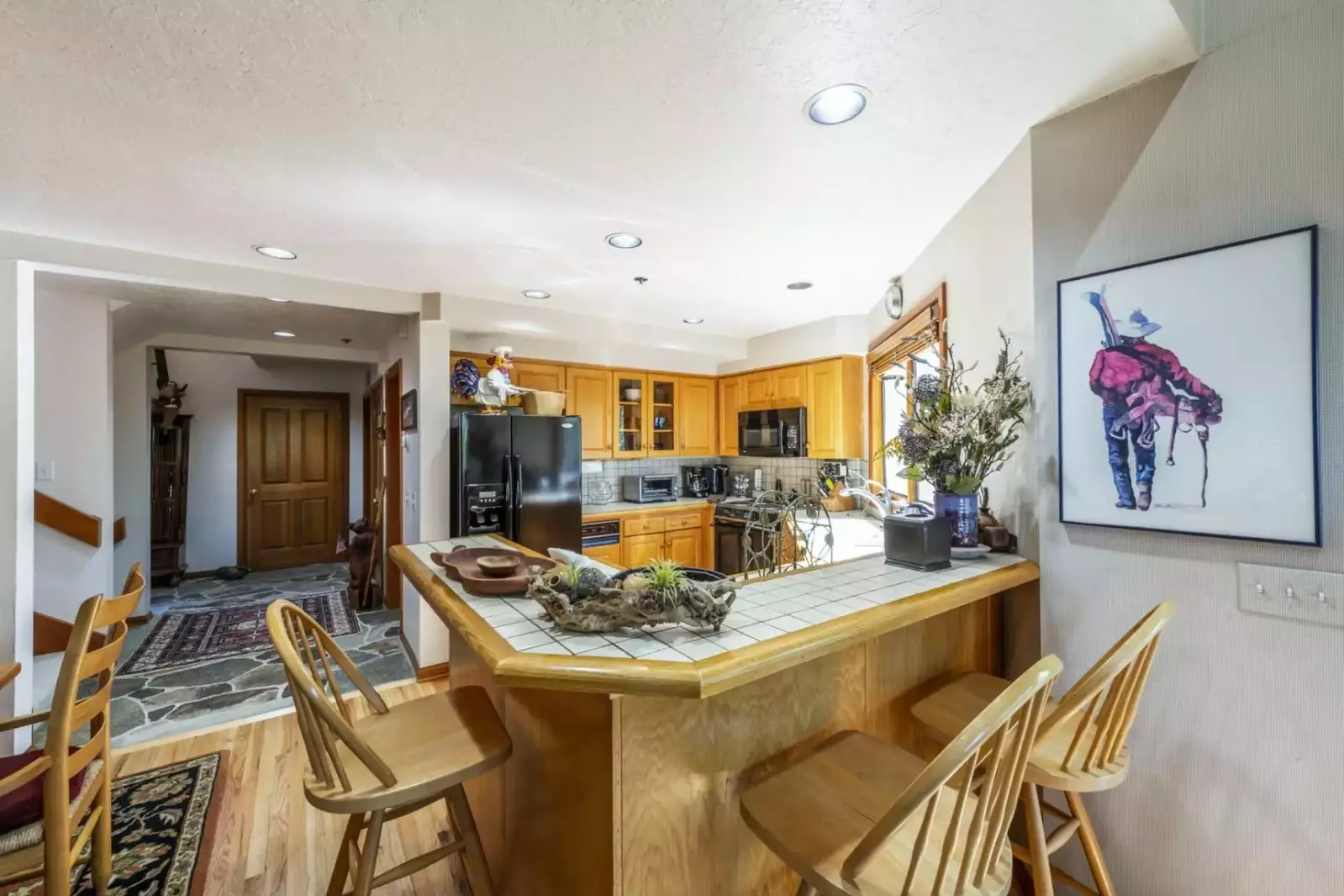 The breakfast bar provides the perfect place to gather in the kitchen. In addition to the seats at the table, this provides seating for another three