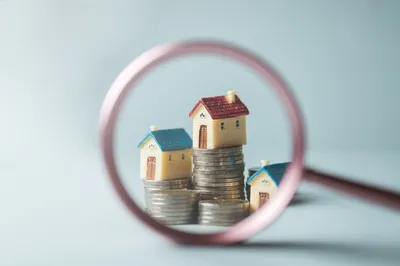 model houses and coins showing property management success