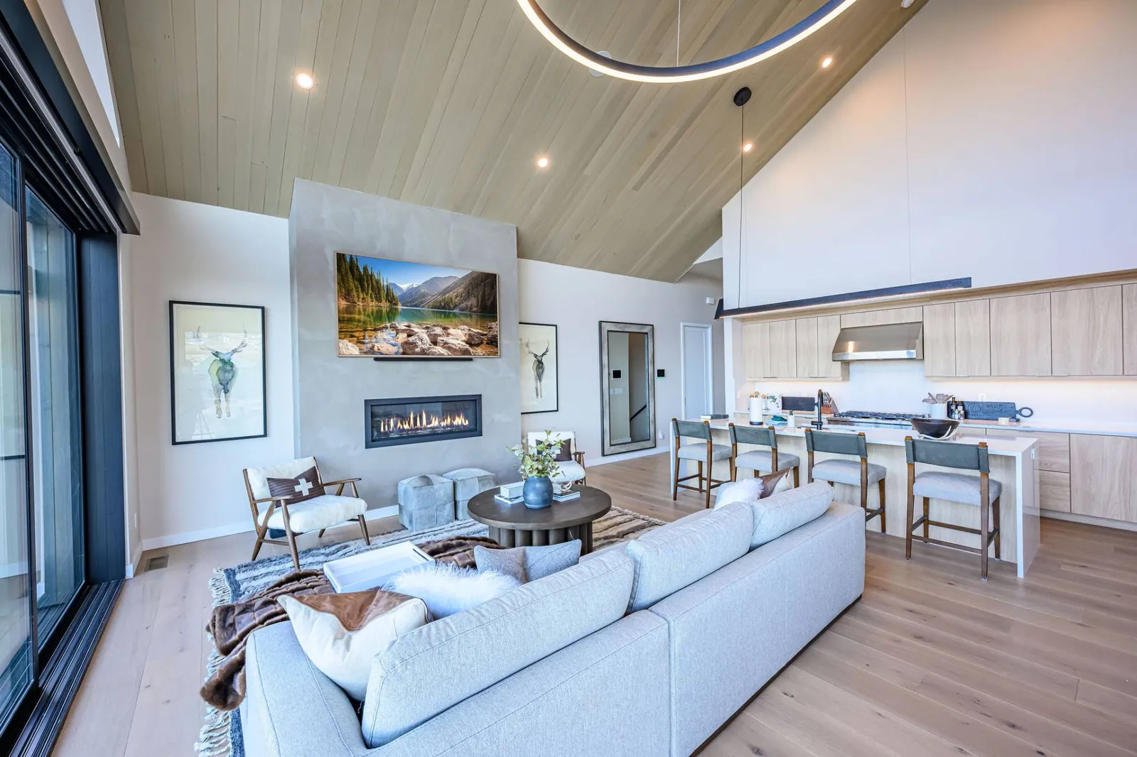 Modern mountain living room with fireplace and panoramic Wasatch Range views