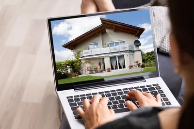 person looking at rental house on computer