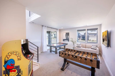 Game on! Enjoy endless fun and entertainment in the private game room that features an air hockey table, Pac Man arcade game, and foosball table