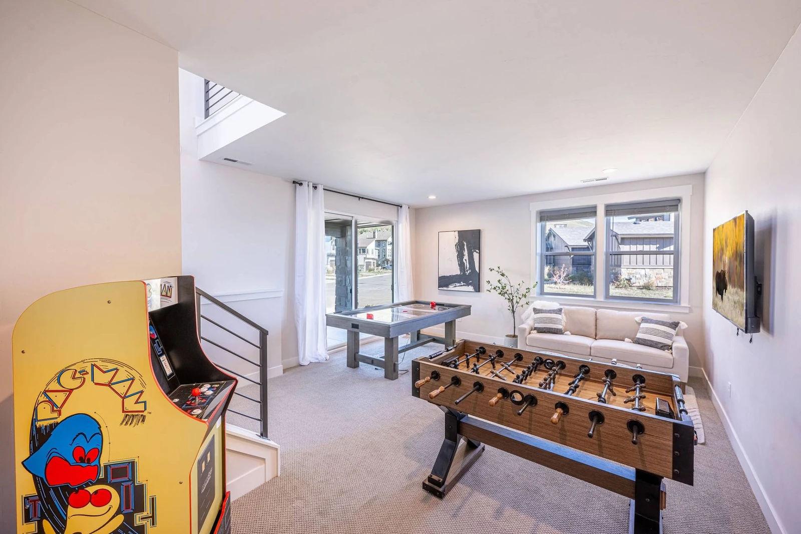 Game on! Enjoy endless fun and entertainment in the private game room that features an air hockey table, Pac Man arcade game, and foosball table