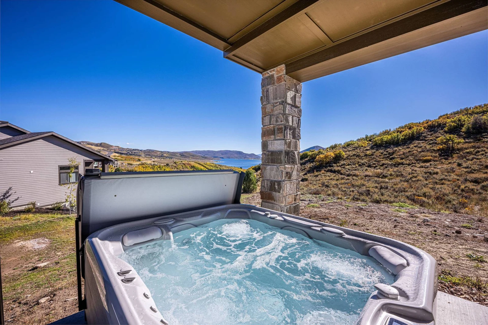 Unwind in our Vacation Rental with a Scenic Hot Tub View. Brand new hot tub with seating for 6 guests and gorgeous Mountain and Lake Views!