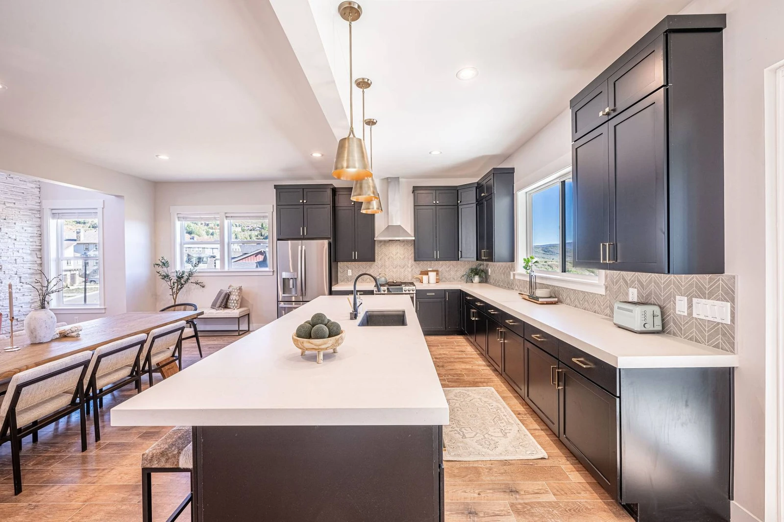 Experience culinary excellence with a spacious gourmet kitchen that features an eat-in bar and stunning views of the Jordanelle Reservoir