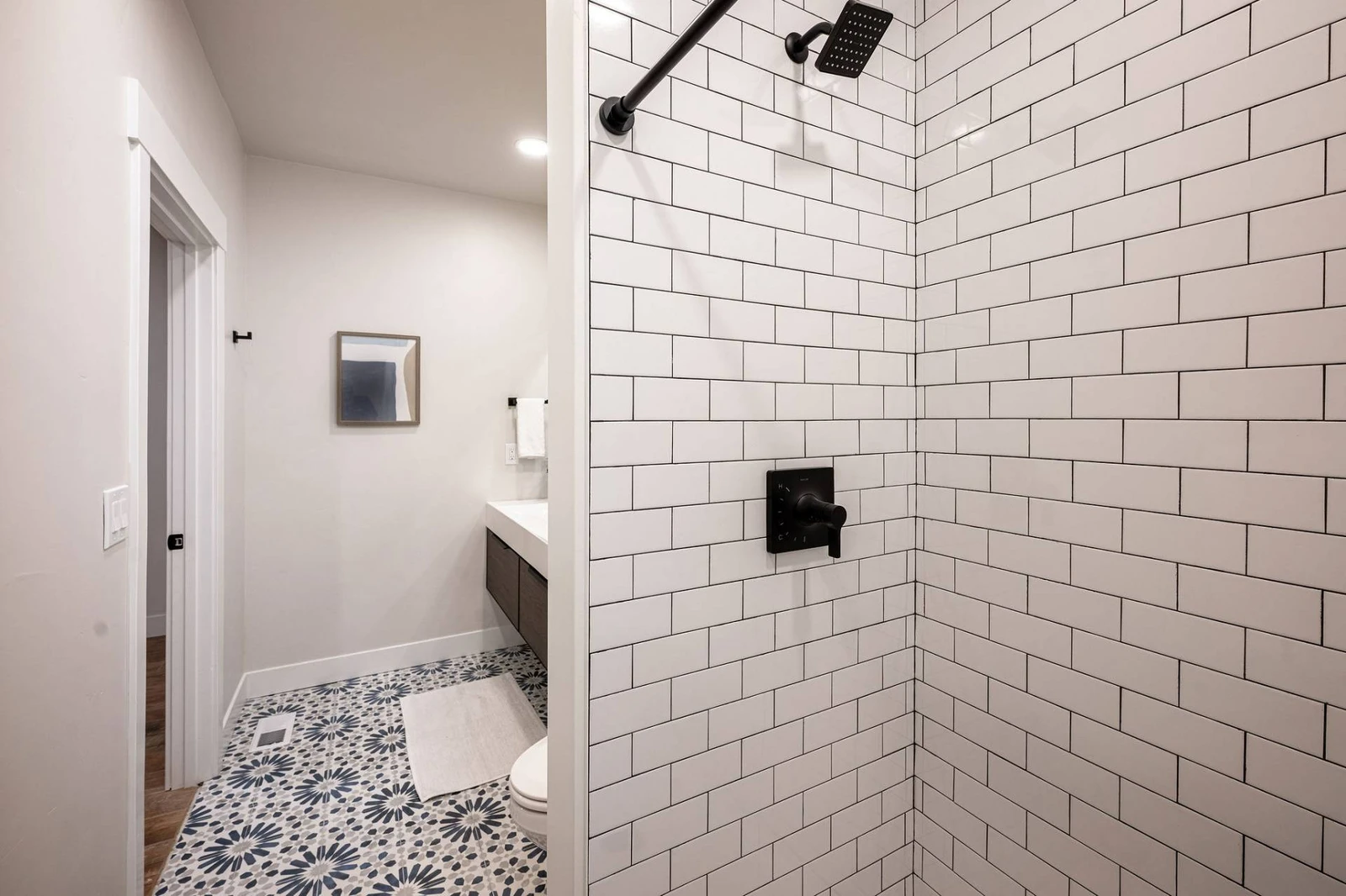 This large bathroom with an oversized walk in shower is a jack-and-jill  bathroom that is shared with the theater room and one other bedroom