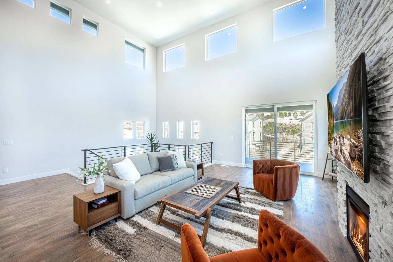 The main living room features ample space for guests to relax and a private balcony