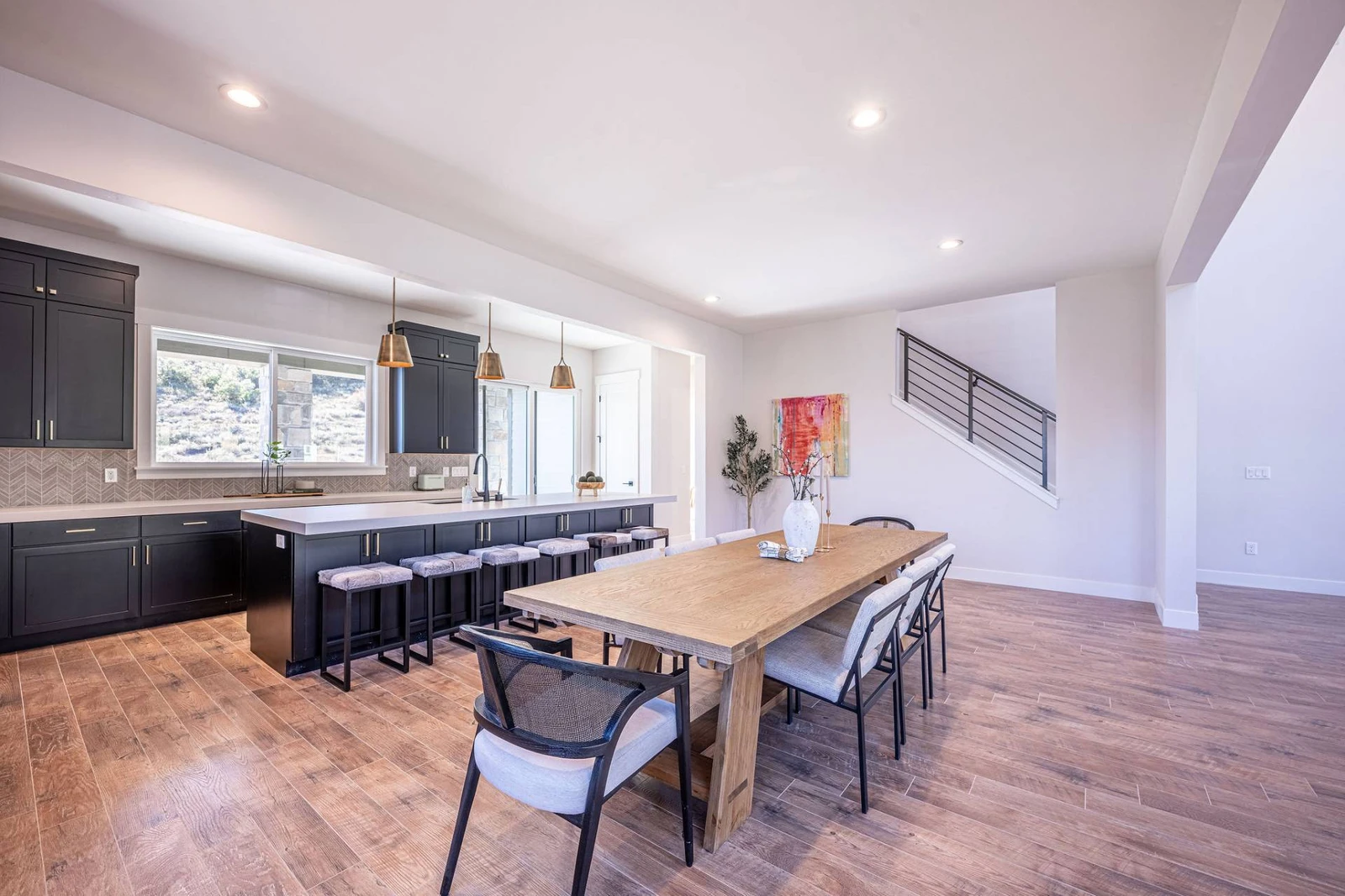 The oversized kitchen table and island both have seating for guests to eat.